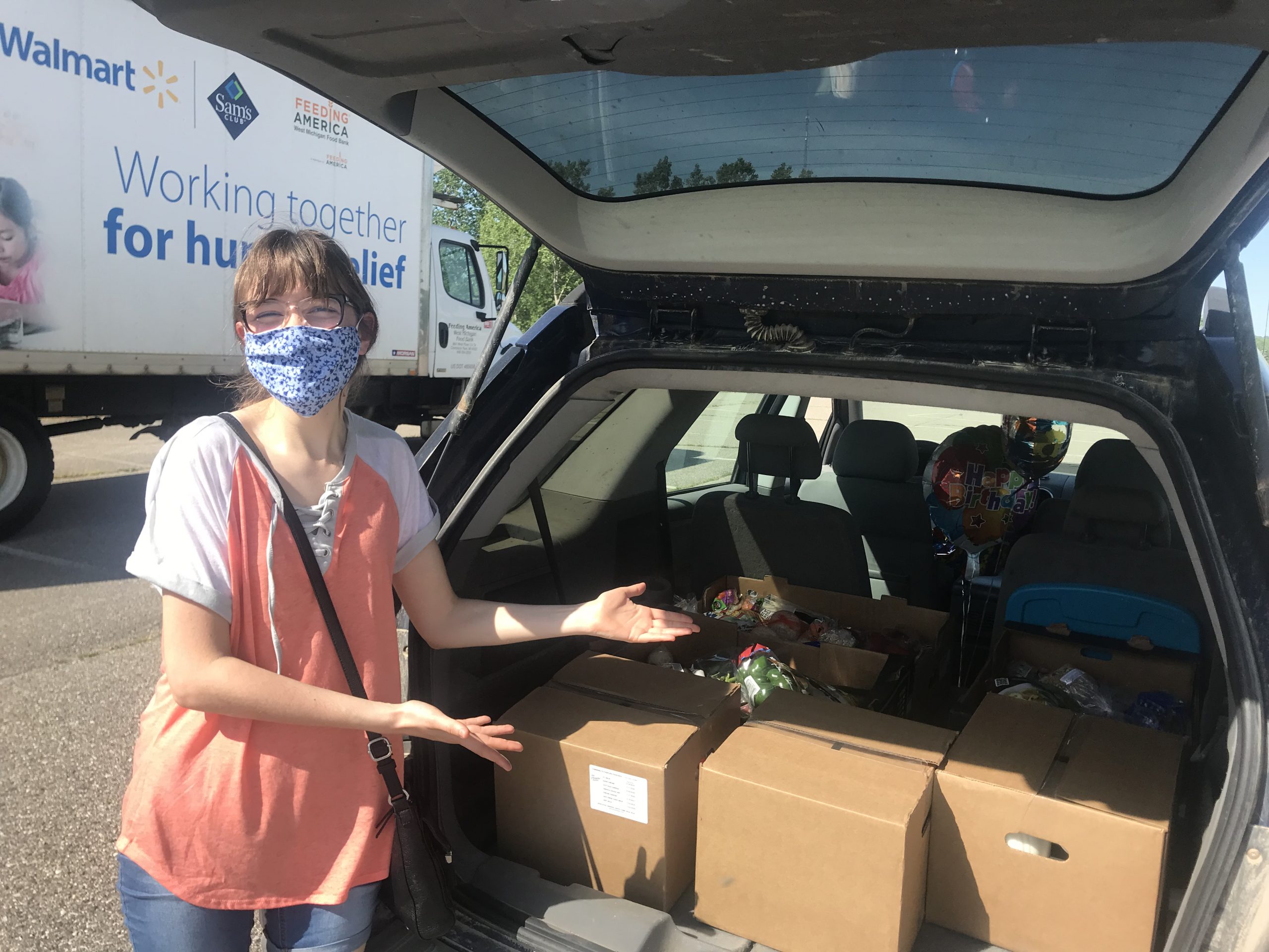 Katie poses with the food she received at the Mobile Pantry