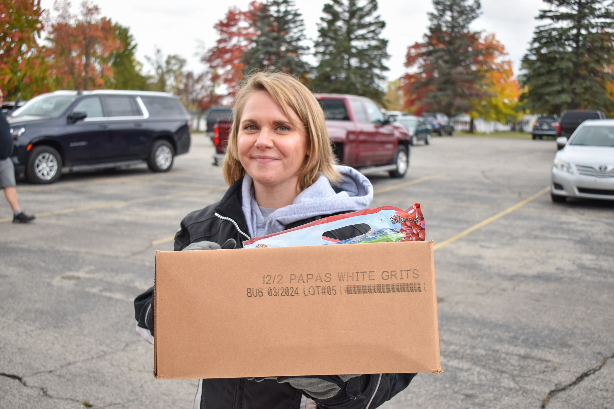 Volunteer holding a box of food at a Mobile Pantry