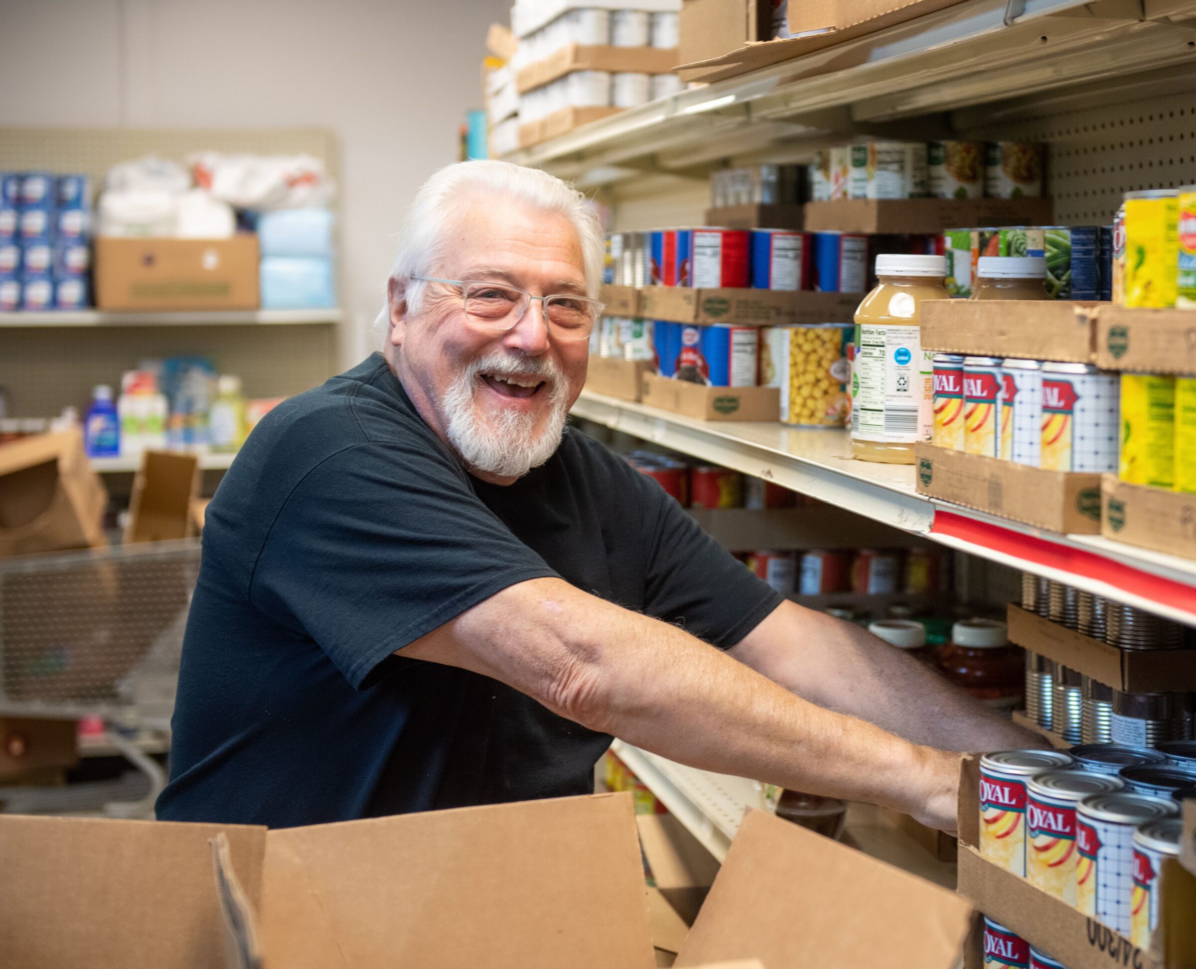 Volunteer sorting cans at a food pantry