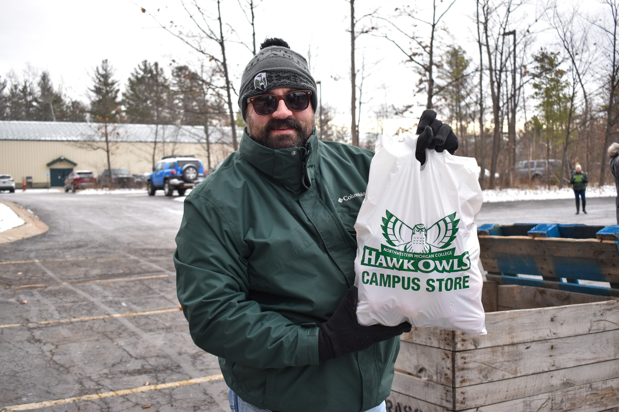 Volunteer holding up a bag of food at a Mobile Pantry